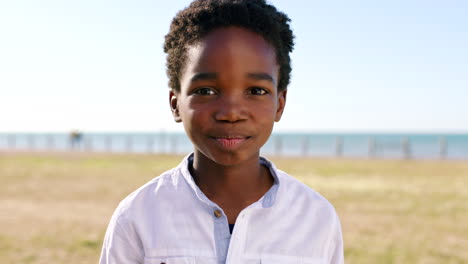 black african boy, face and outdoor park by beach