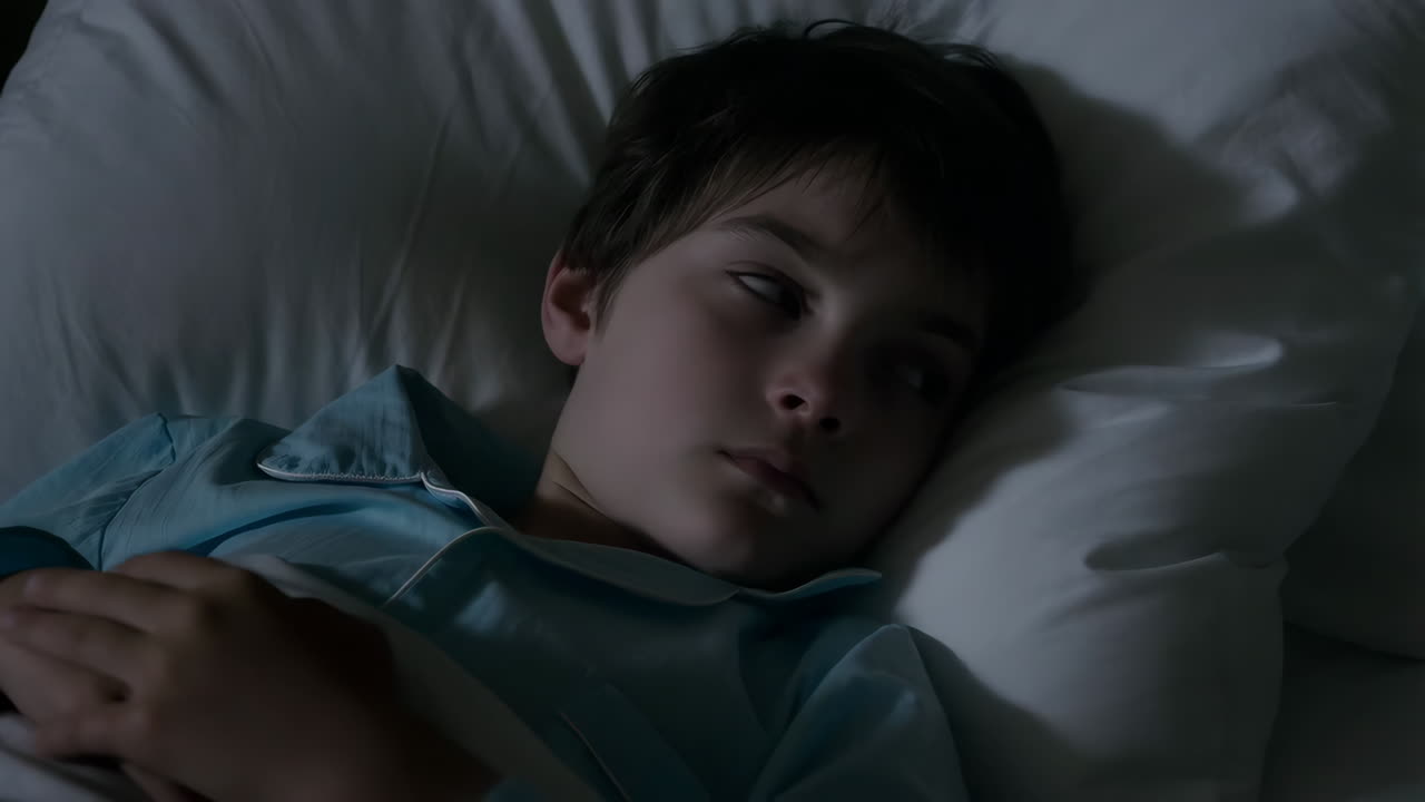 Boy sleeping in bed at night