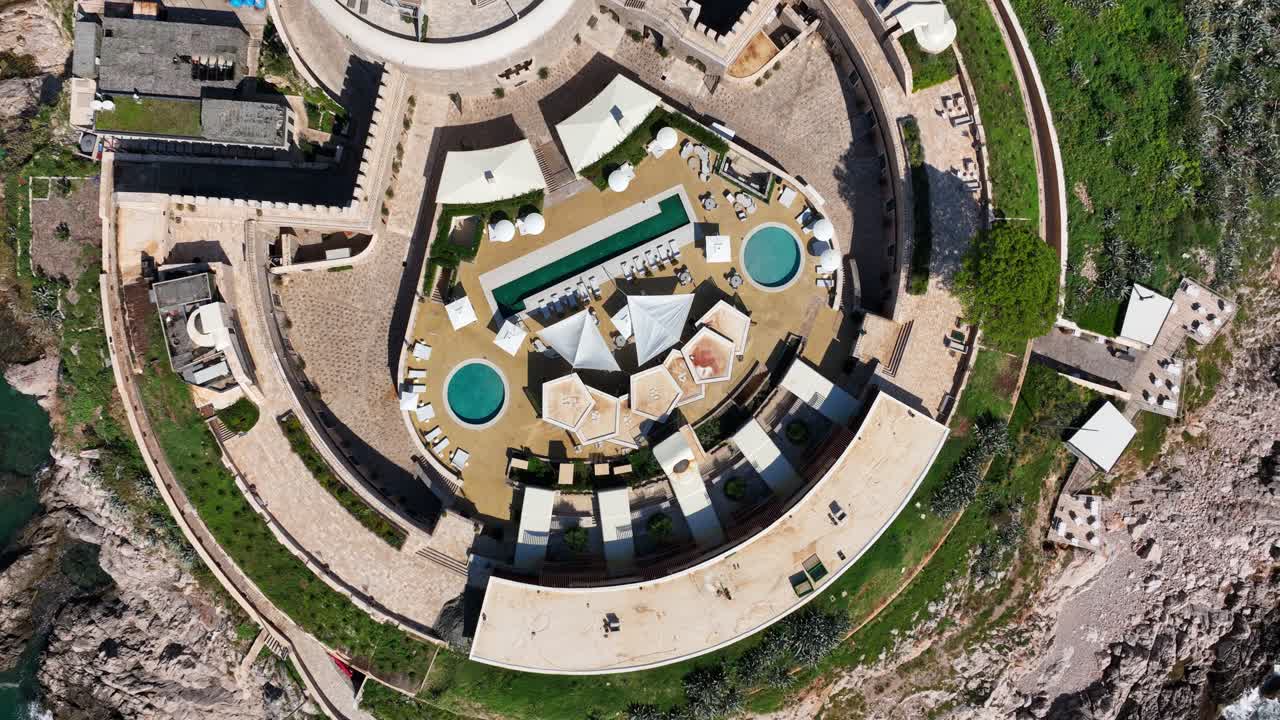 Aerial View Of Mamula Island Hotel In Montenegro - Circular Fortress Island Hotel And Resort With Outdoor Pools. topdown rotating shot