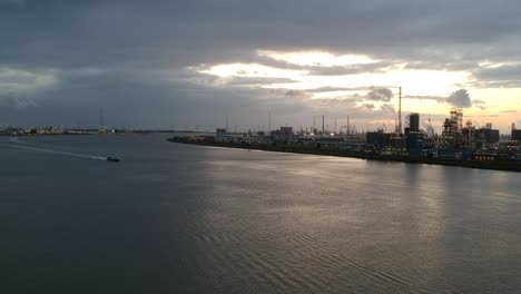 industrial buildings of antwerp harbor with evening lights, drone aerial view