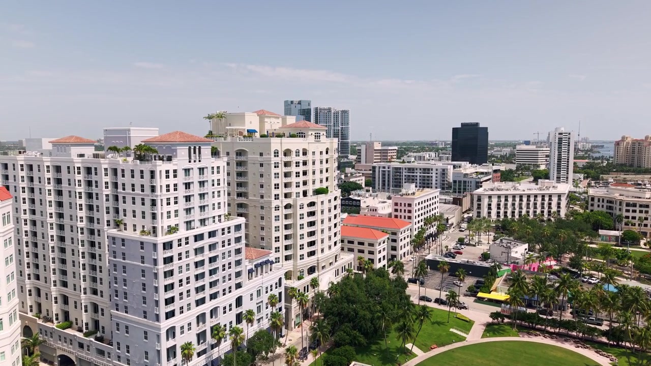 Parco lungomare fiancheggiato da palme circondato dal centro di West Palm Beach, ascesa aerea sopra l'Anfiteatro Meyer per rivelare la città.