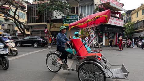 cyclo and motorbike traffic at a busy city crossroad