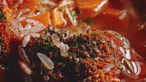 Close-Up-View-Of-Paprika,-Oregano-Powder-Along-With-Dry-Rice-In-Cooking-Pot