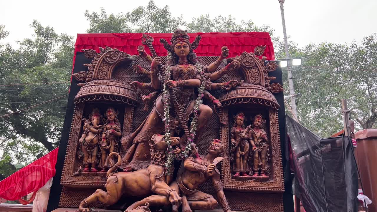 Devi Durga idol with bronze look at carnival procession at Red Road in Kolkata, India.