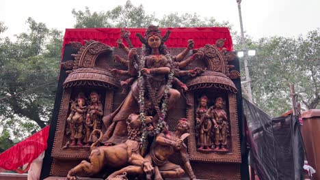 devi durga idol with bronze look at carnival procession at red road in kolkata, india.