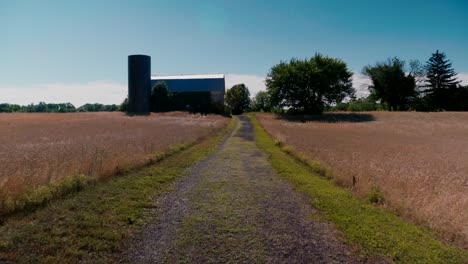 Dolly-in-to-Farm-house-on-Road