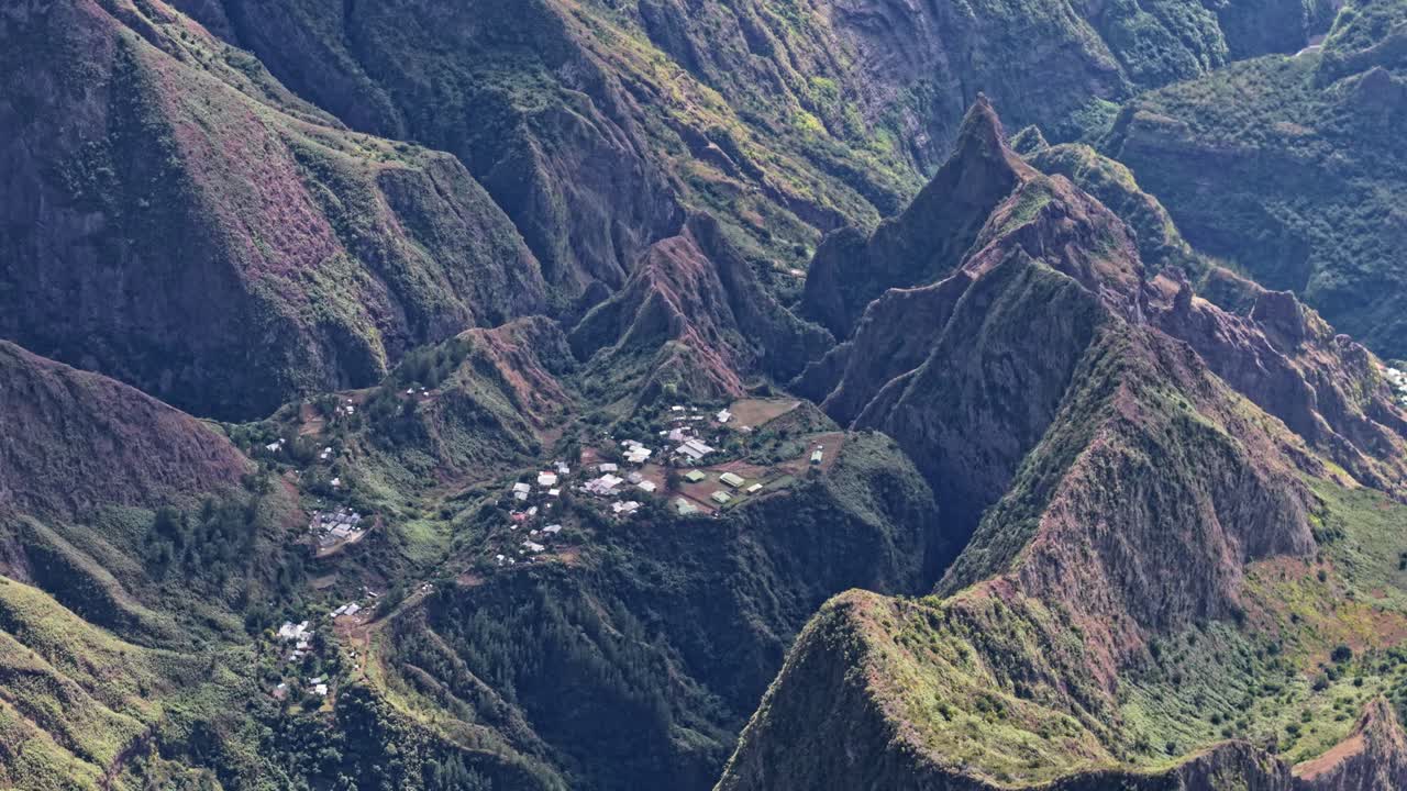 small village surrounded by mountains in the Mafate cirque, Reunion, droneshot