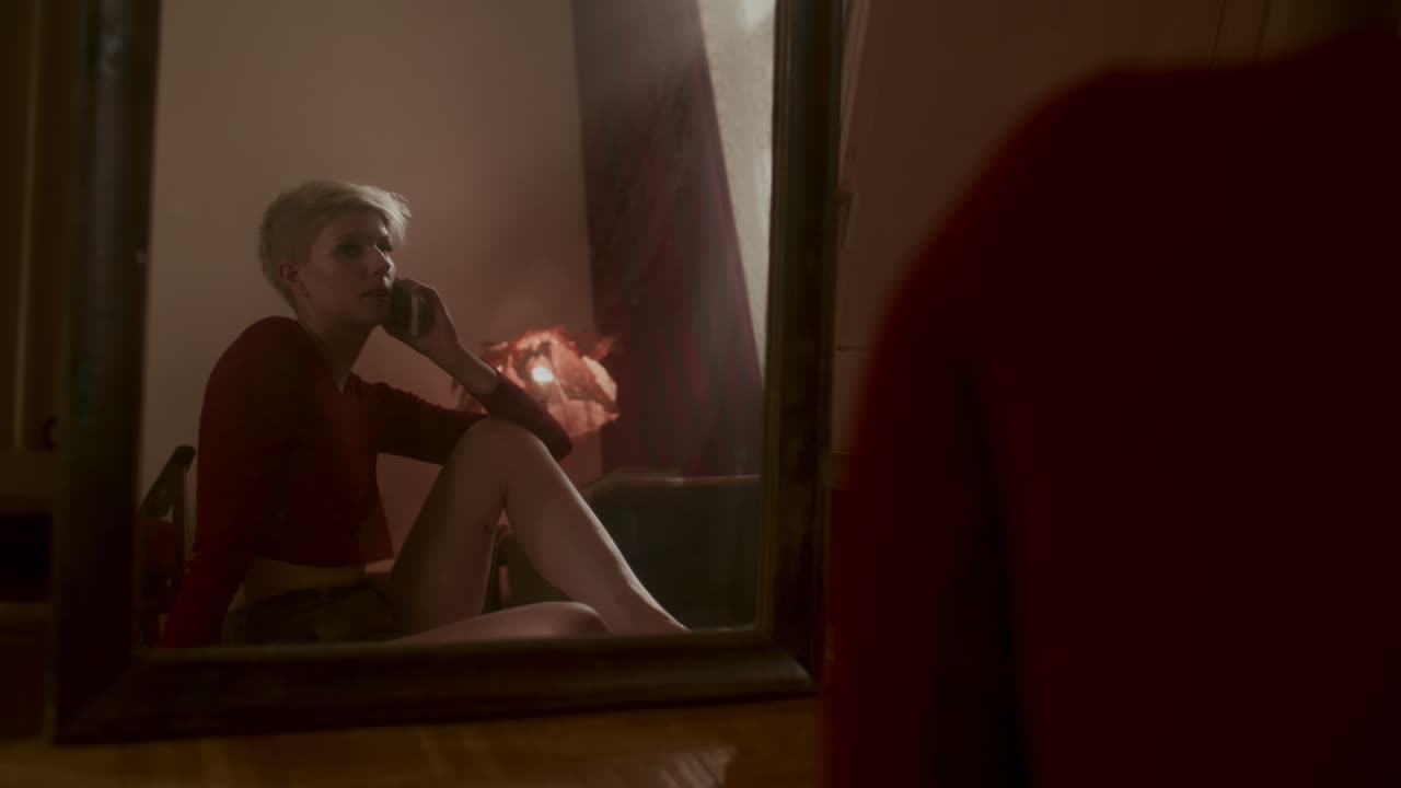 Woman talking on phone in a bedroom