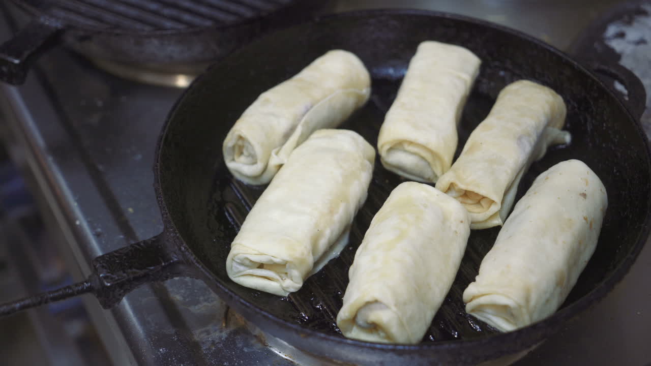 Frying pancakes with fillings on a skillet. Traditional kitchen.