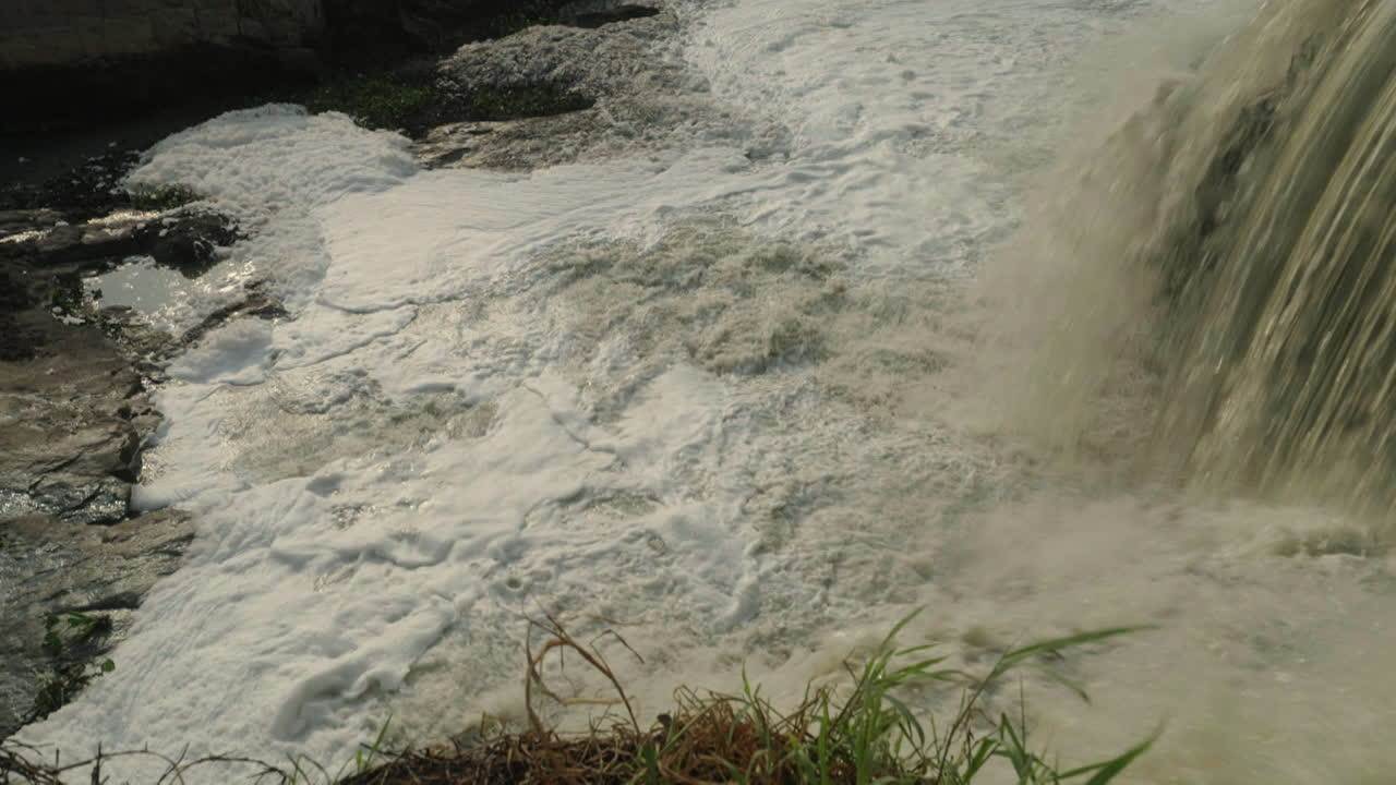 Polluted Waterfall with Foam