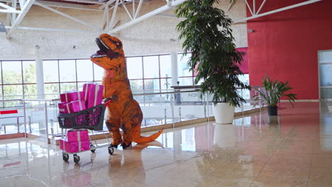 dinosaur in shopping cart at mall