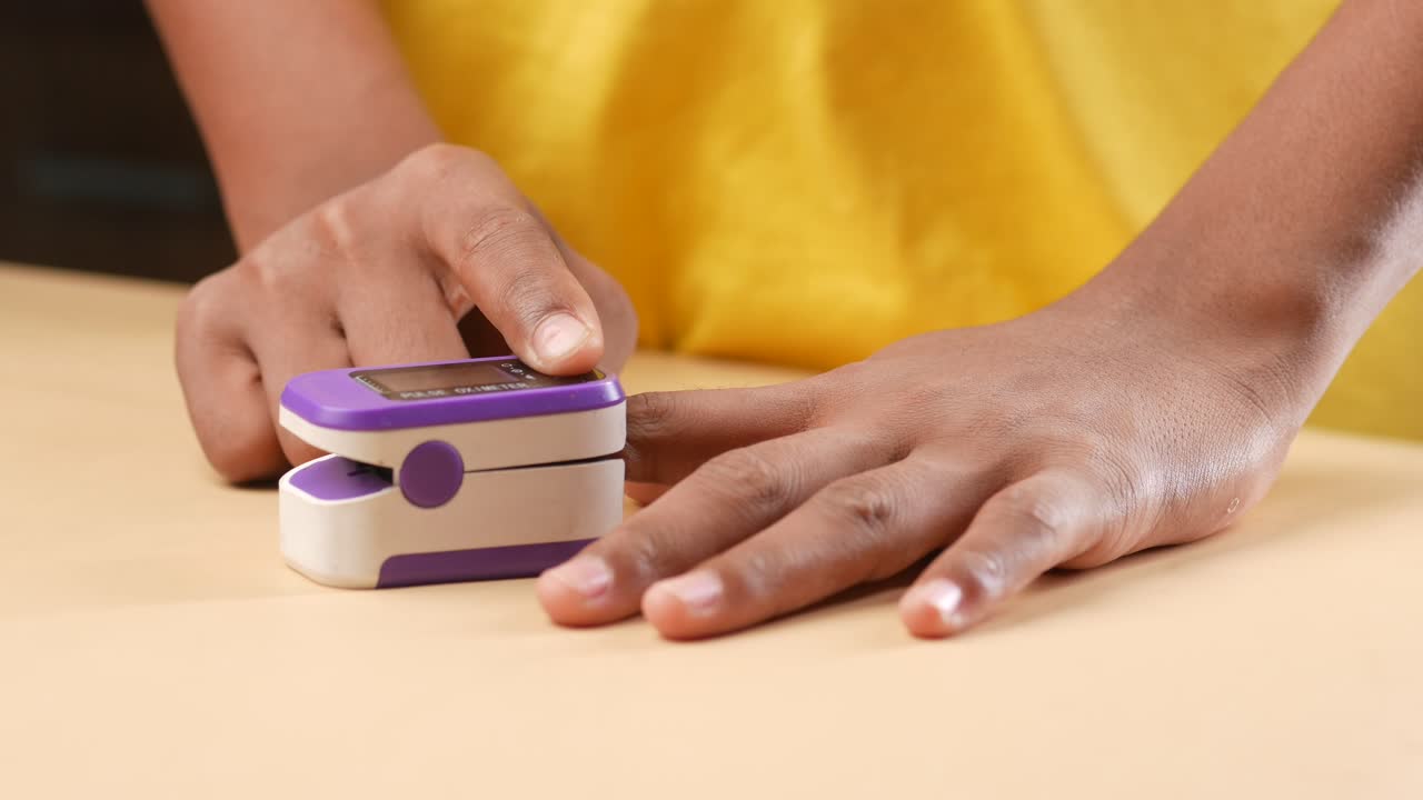 Young man hand using pulse oximeter