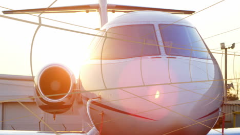 white private jet being rendered in 3d on airport ramp, with safety ropes reflecting warm light