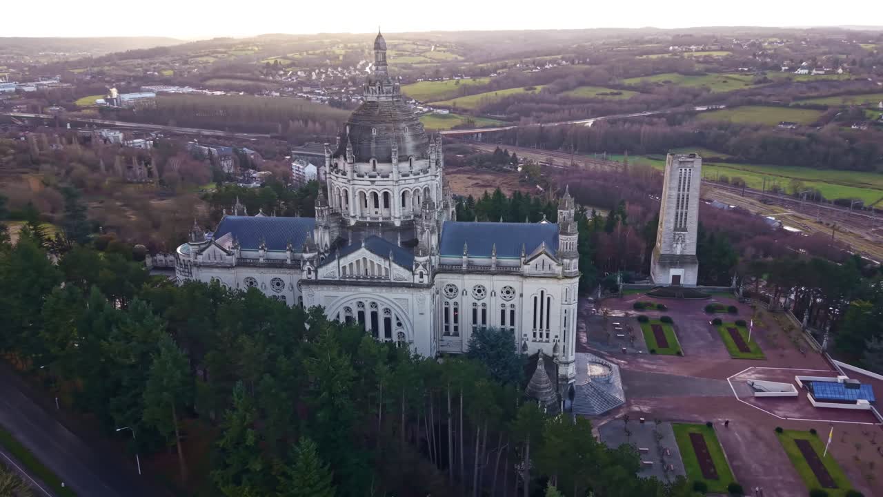 Drone slowly orbits the Basilica of Lisieux with town and countryside around