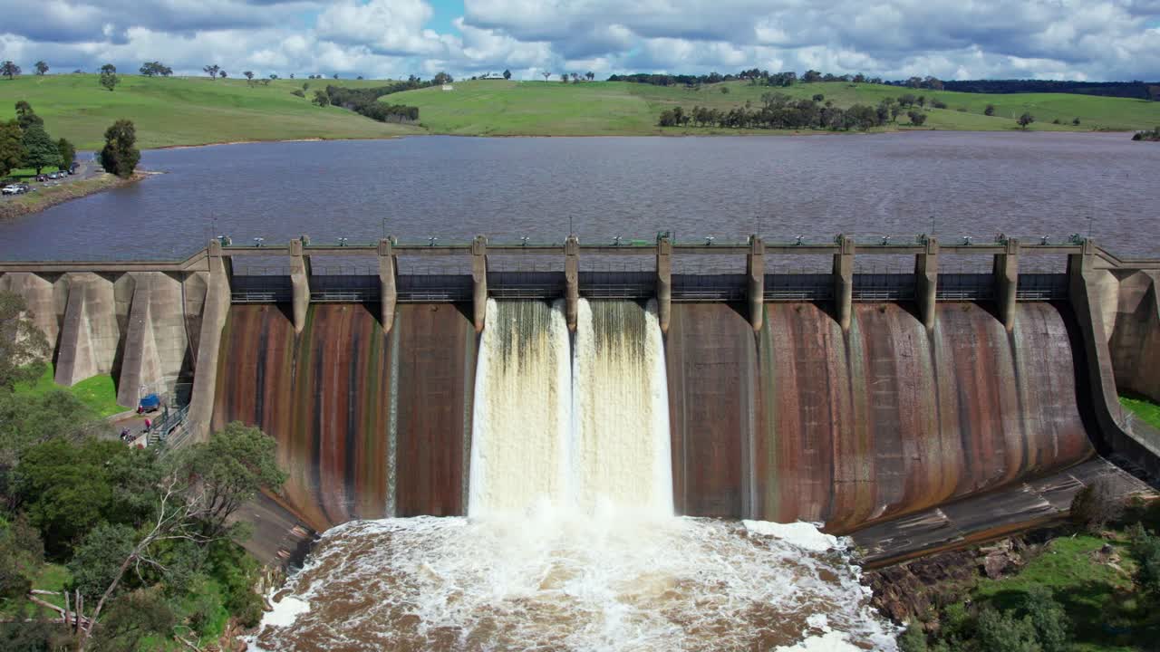 Slow forward moving and panning down aerial footage of water being released from Lauriston Reservoir, in central Victoria. October 2022.