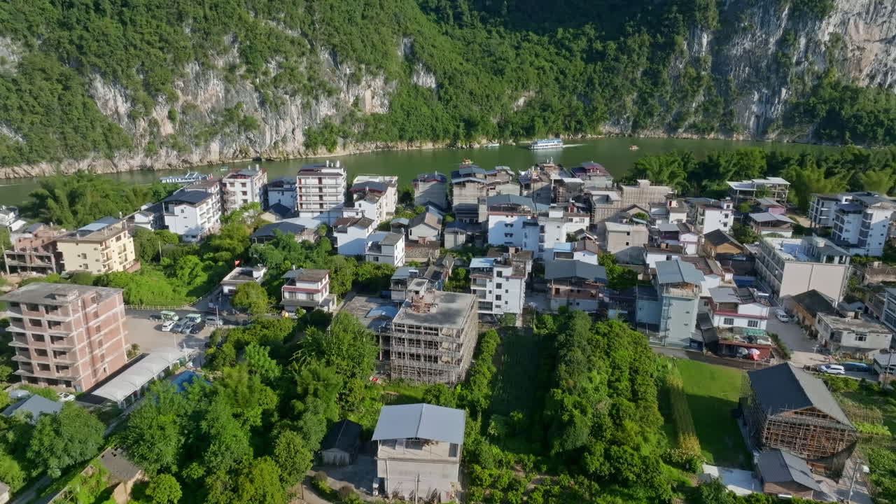 Aerial tracking shot in front of homes in Xingping Ancient Town, summer in China