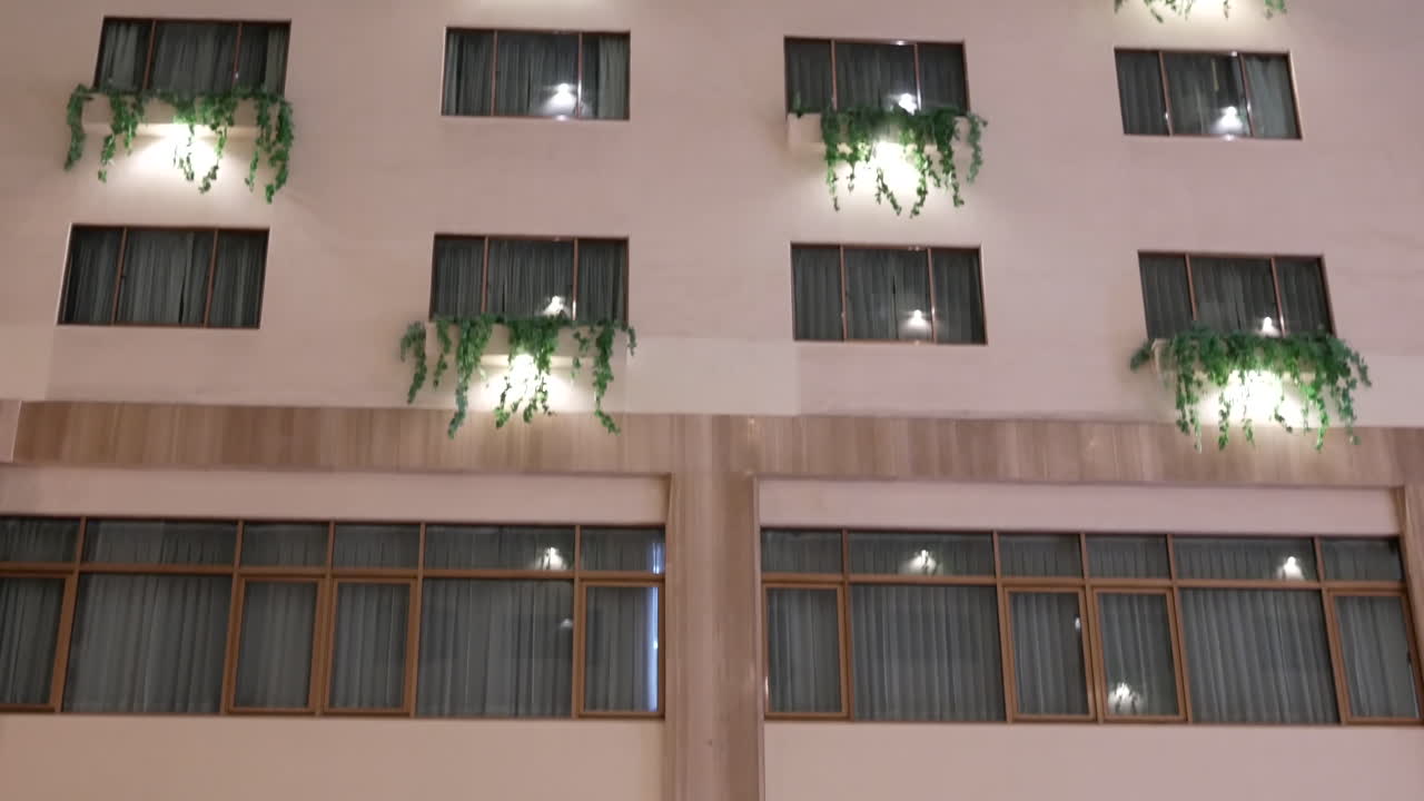 Tilt shot of high rise hotel building inside big shopping mall with 4k resolution