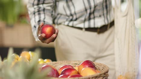 Mid-section-of-senior-african-american-man-shopping-at-health-food-shop,-slow-motion