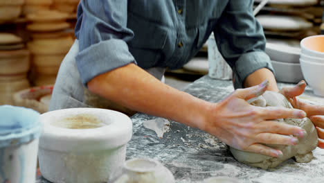 mid section of female potter molding a clay 4k