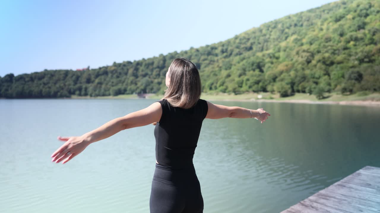 Woman enjoying the scenic view of a lake
