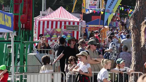 crowded festival scene with colorful booths and visitors