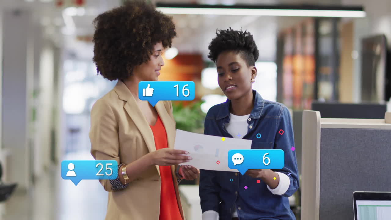 Animation of social media icons with numbers over african american female colleagues in office