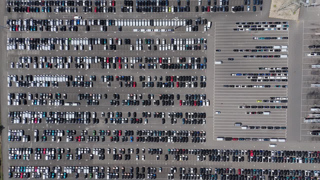 Aerial drone view of rows of new vehicles at dealership and export terminal in Grimsby England UK for import and export logistics