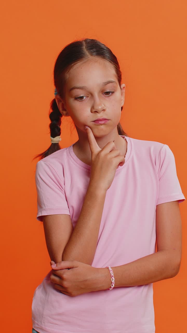 Thoughtful clever young preteen child girl kid pondering a solution doubting question brainstorming