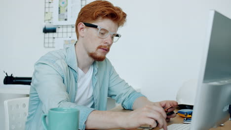 man working on computer in an office environment