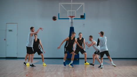 High-school-team-playing-basketball-indoors,-practicing-combinations-and-drills.-4K-UHD