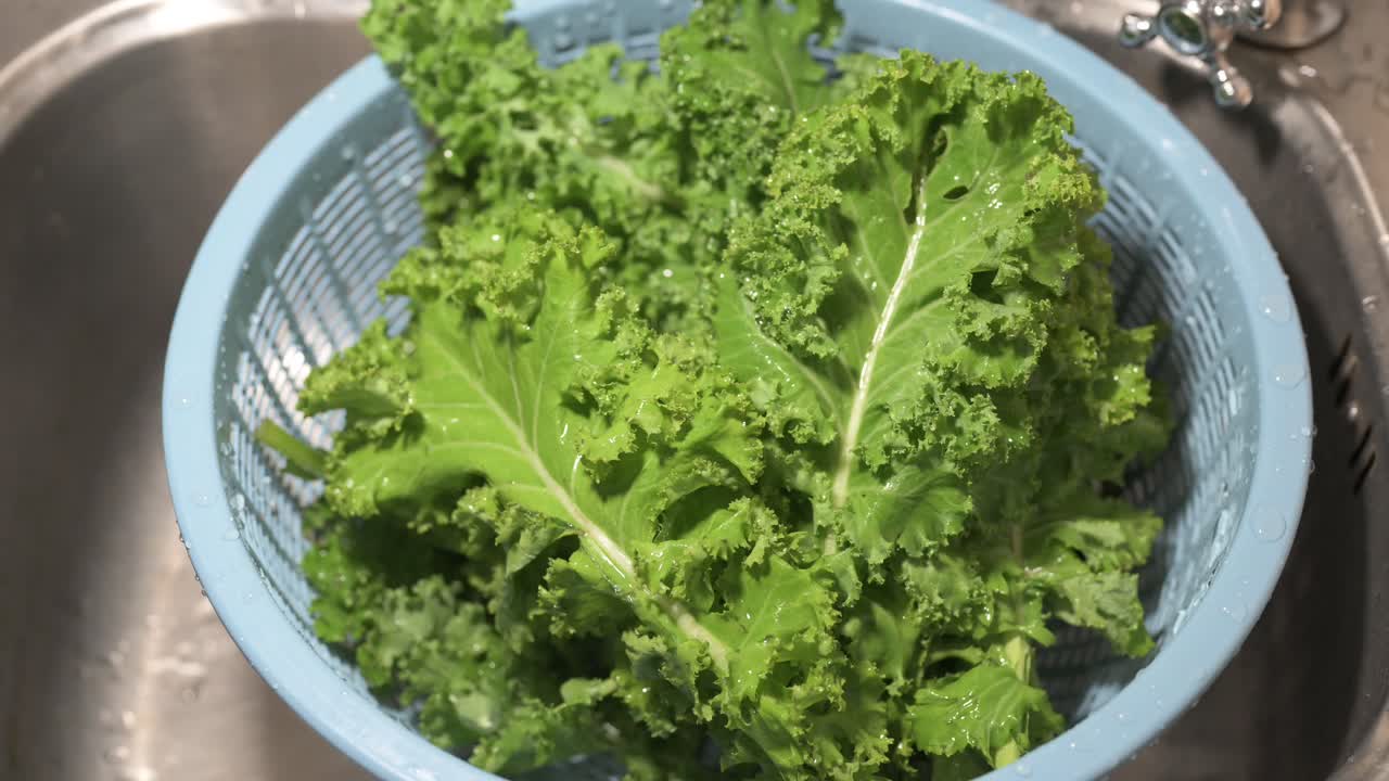 Close-up shot of fresh raw organic kale leaves ready to be prepared at home kitchen close-up