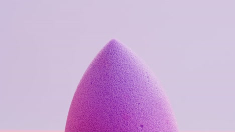 purple makeup sponge with foundation