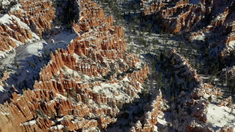 snow-covered red rock canyon landscape with hoodoos