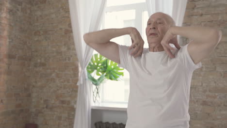 Old-Male-Exercising-And-Stretching-At-Home-Close-Up