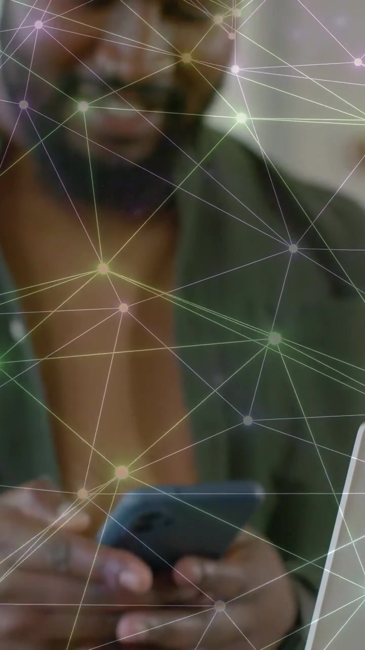 Video verticale: Uomo che prende il telefono e lo usa per la tecnologia, con elementi di rete, una tazza e un laptop.
