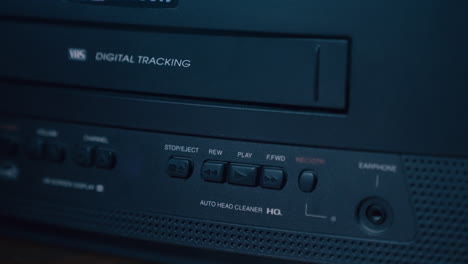 pressing play on vintage television and vcr with buttons