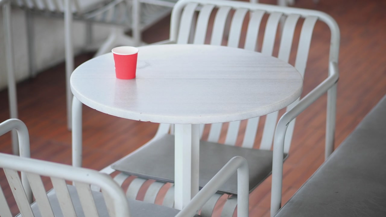 Red Paper Cup on a White Table in an Empty Cafe