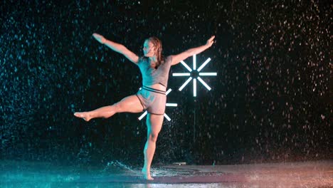 young girl modern dancer dancing in the rain, slow motion effect