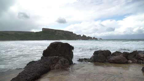 Algae-Grows-on-Stone-near-Ghajn-Tuffieha-Bay-Shore-with-Sea-Waves-Crashing-and-Splashing