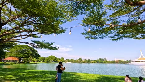 people enjoying nature by a serene pond