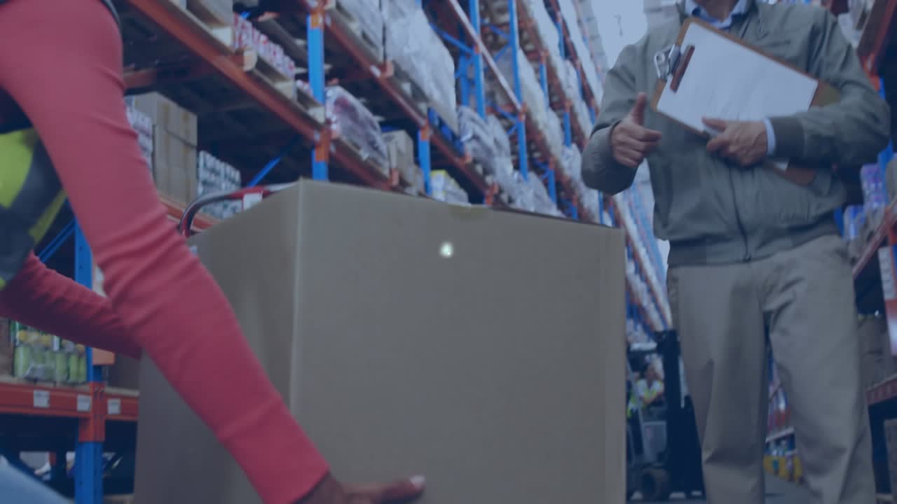 Animation of network of icons over caucasian male supervisor showing thumbs to worker at warehouse