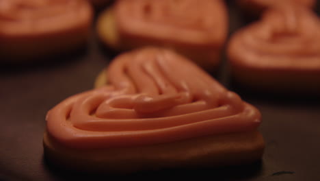 heart-shaped cookies with pink frosting and red sprinkles