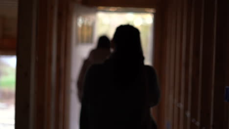 daughter showing her mother her first home - new home construction site