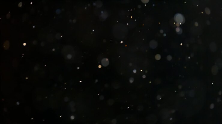Floating abstract particle bokeh on dark background