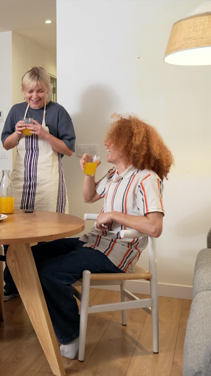 Friends Toasting with Orange Juice at Breakfast