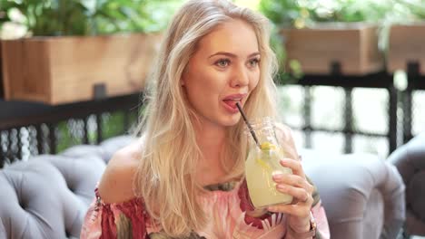 woman enjoying lemonade in a cafe