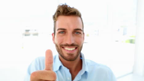 Businessman-drinking-coffee-and-giving-thumbs-up