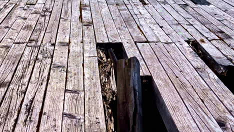 weathered wooden planks with broken and warped boards on old surface structure