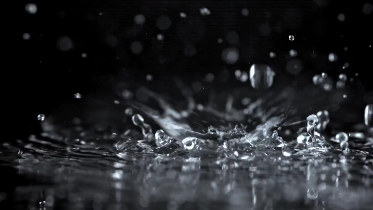 Slow Motion Water Drops Splashing on a Black Surface