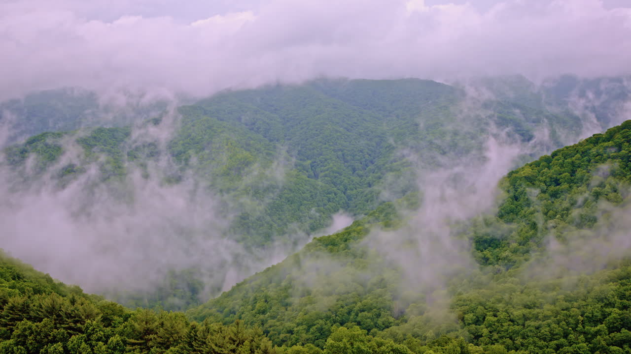 Aerial cinematic view of the Great Smoky Mountains veiled in fog and mist